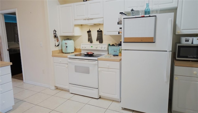 kitchen with white cabinetry, light tile patterned floors, and white appliances