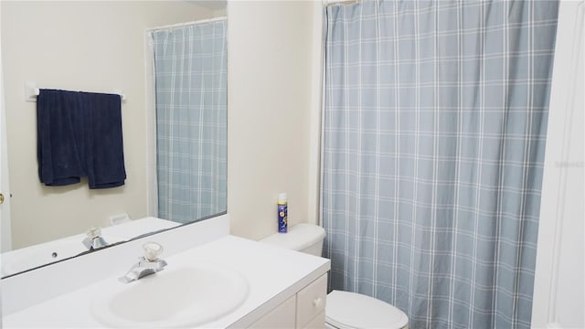 bathroom featuring vanity and toilet