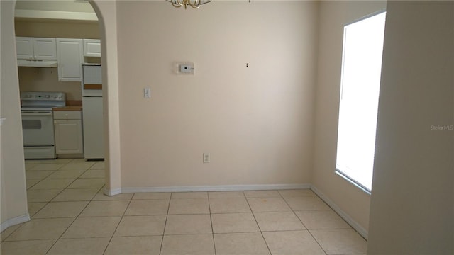 unfurnished dining area with light tile patterned flooring