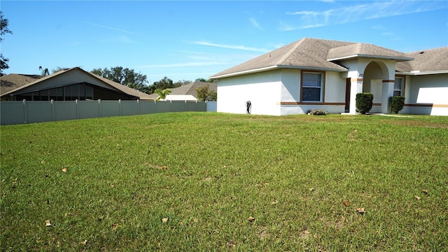 view of side of property with a yard