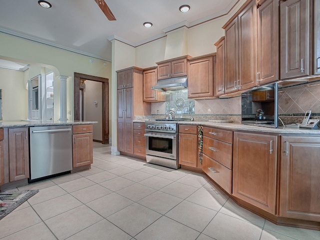 kitchen featuring decorative backsplash, light tile patterned floors, light stone counters, and appliances with stainless steel finishes