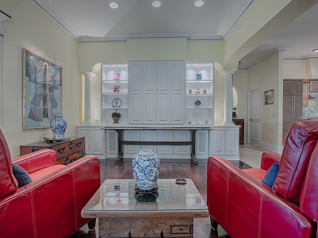 living room with dark wood-type flooring, ornate columns, and crown molding