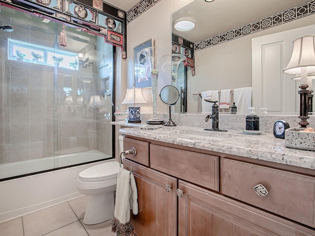 full bathroom with toilet, vanity, tile patterned floors, and shower / bath combination with glass door