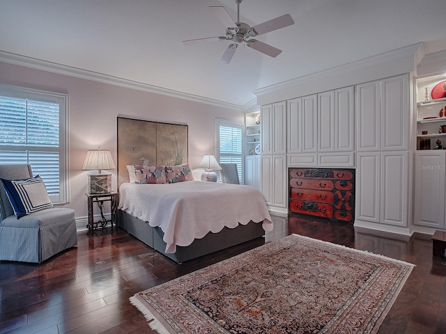 bedroom with ceiling fan, dark hardwood / wood-style floors, crown molding, and vaulted ceiling