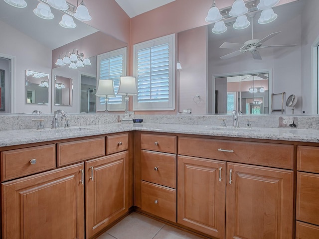 bathroom featuring ceiling fan, vanity, vaulted ceiling, tile patterned floors, and a shower with shower door