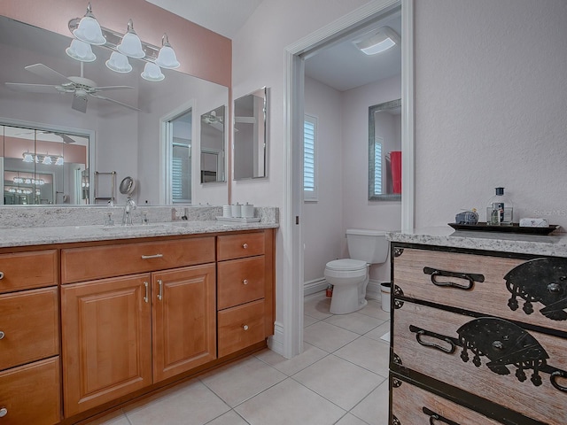 bathroom with toilet, ceiling fan, tile patterned flooring, and vanity