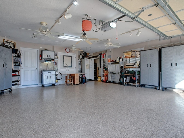 garage with ceiling fan and a garage door opener