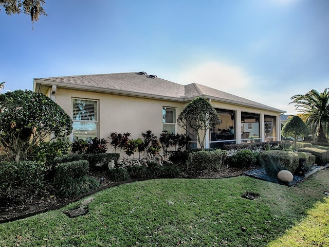 view of front of house featuring a front yard and a sunroom