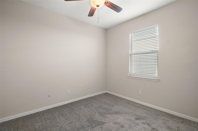 carpeted spare room featuring ceiling fan