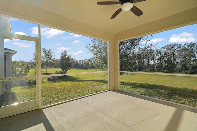 unfurnished sunroom with ceiling fan