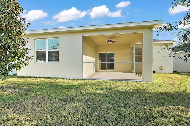 back of house featuring a patio area, ceiling fan, and a lawn