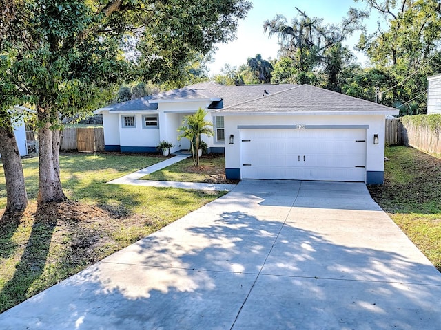 ranch-style house featuring a front yard and a garage