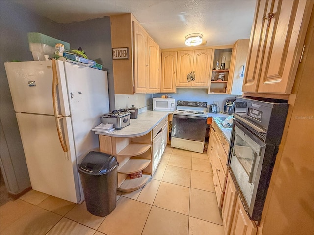 kitchen featuring white appliances, light tile patterned floors, and light brown cabinets