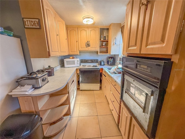 kitchen with white appliances, light tile patterned flooring, and light brown cabinetry