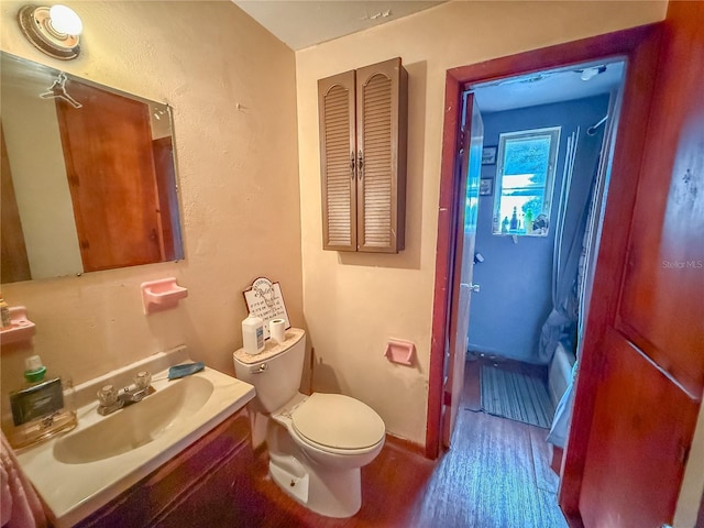 full bathroom with toilet, vanity, shower / tub combo with curtain, and hardwood / wood-style flooring