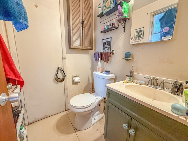 bathroom featuring tile patterned floors, vanity, and toilet