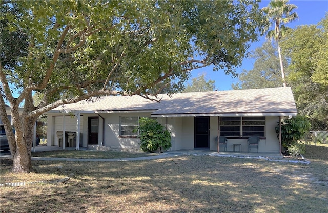 view of front of house with a patio and a front lawn