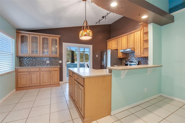 kitchen featuring appliances with stainless steel finishes, pendant lighting, backsplash, and kitchen peninsula