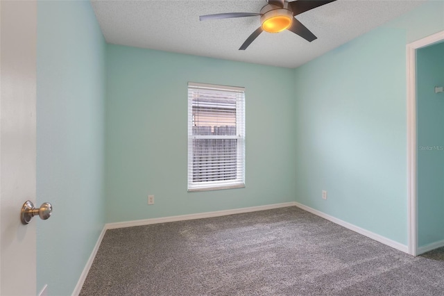 carpeted spare room featuring a textured ceiling and ceiling fan