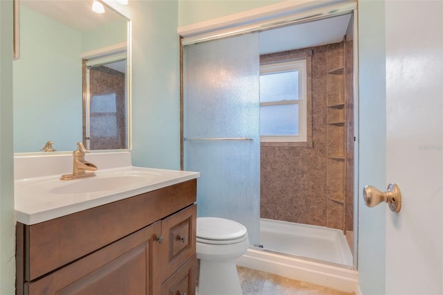 bathroom featuring an enclosed shower, vanity, and toilet