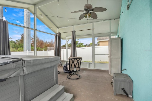 sunroom featuring ceiling fan and vaulted ceiling