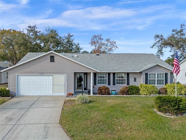 ranch-style house featuring a front lawn and a garage