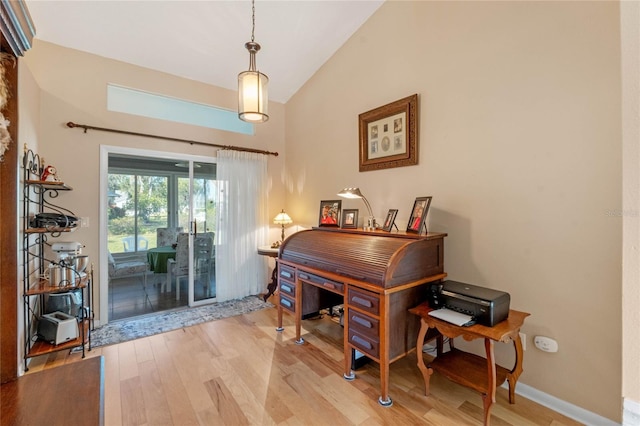 office space featuring light hardwood / wood-style floors and vaulted ceiling