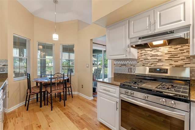 kitchen featuring pendant lighting, white cabinets, dark stone counters, tasteful backsplash, and stainless steel gas stove