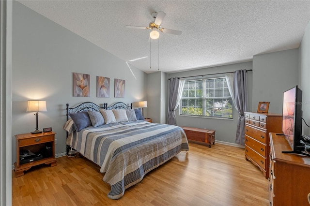 bedroom featuring a textured ceiling, ceiling fan, and light wood-type flooring