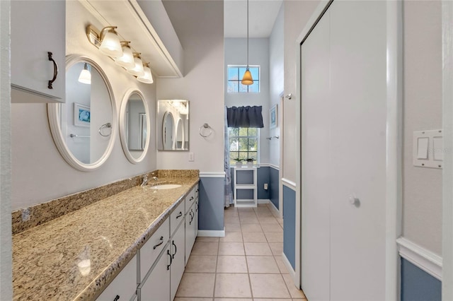 bathroom with tile patterned flooring and vanity