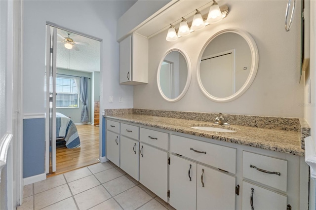 bathroom featuring ceiling fan, tile patterned floors, and vanity