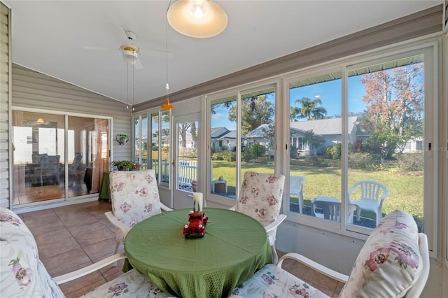 sunroom with vaulted ceiling, ceiling fan, and plenty of natural light