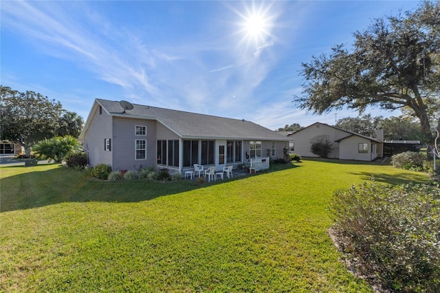 rear view of property featuring a yard