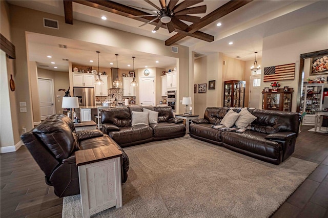 living room with ceiling fan with notable chandelier, dark wood-type flooring, beamed ceiling, and a high ceiling