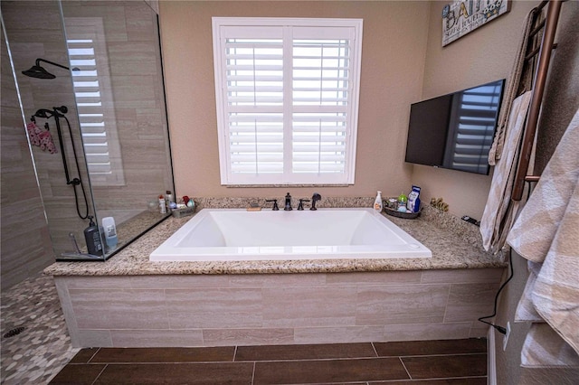 bathroom featuring separate shower and tub