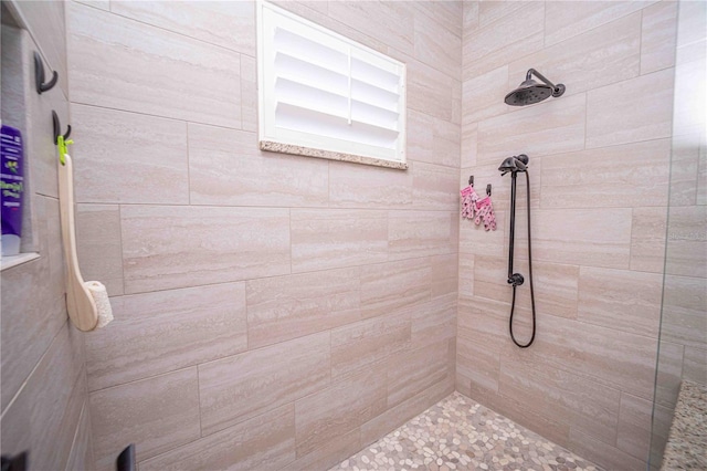 bathroom with tiled shower