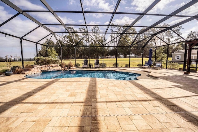 view of pool with pool water feature, a lanai, and a patio area