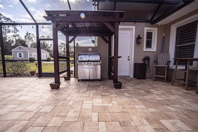 view of patio with a lanai and a grill