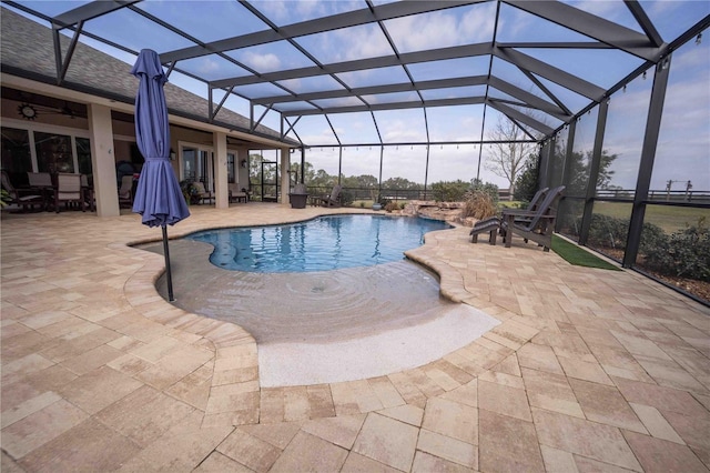 view of pool featuring ceiling fan, a lanai, and a patio area