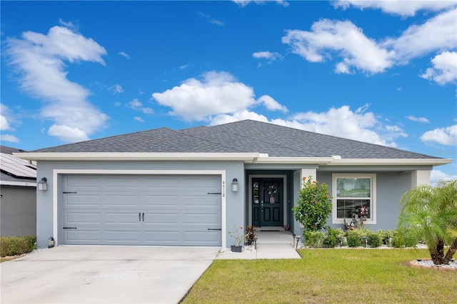 ranch-style home with a front yard and a garage