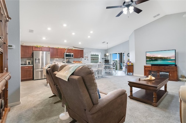 carpeted living room featuring ceiling fan and high vaulted ceiling