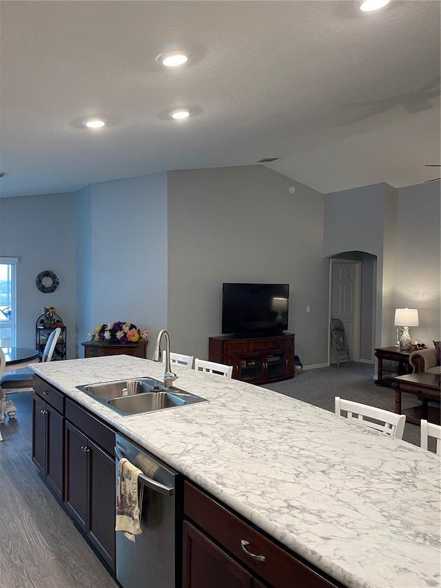 kitchen featuring dark brown cabinets, dark hardwood / wood-style flooring, stainless steel dishwasher, and sink