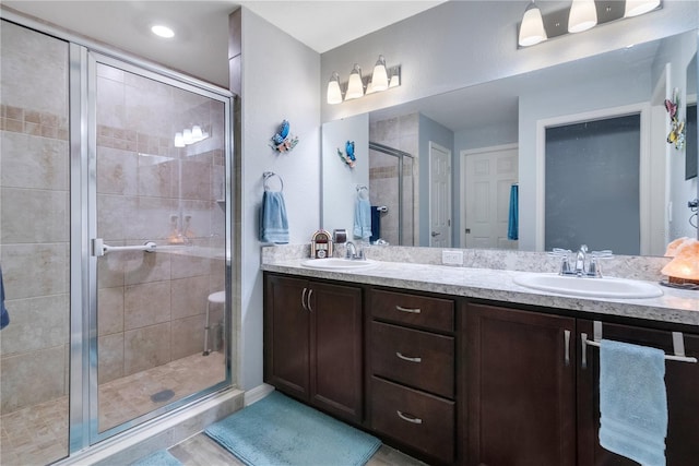 bathroom featuring vanity, tile patterned flooring, and a shower with door