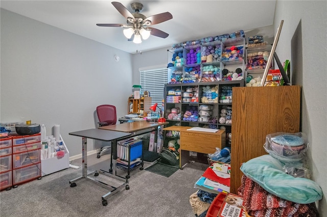 carpeted office space featuring ceiling fan