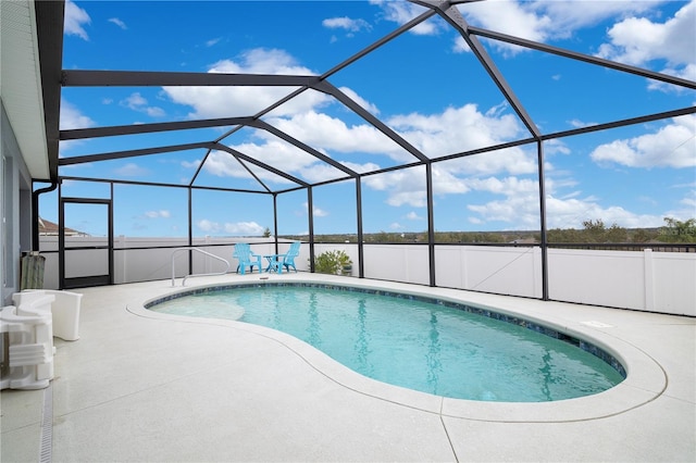 view of swimming pool with a lanai and a patio area