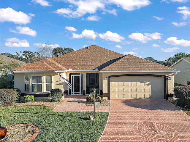 ranch-style home featuring a front lawn and a garage