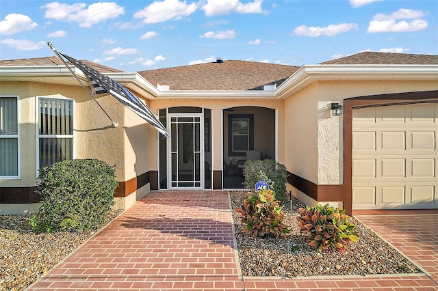 view of exterior entry featuring a garage