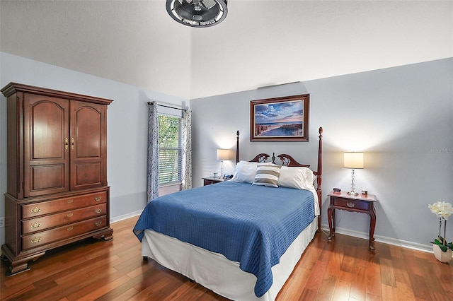 bedroom with dark hardwood / wood-style floors