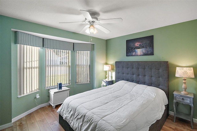 bedroom with ceiling fan and wood-type flooring