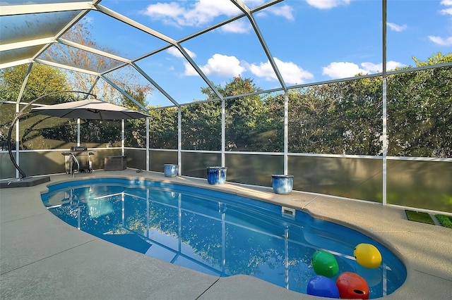 view of swimming pool featuring a lanai